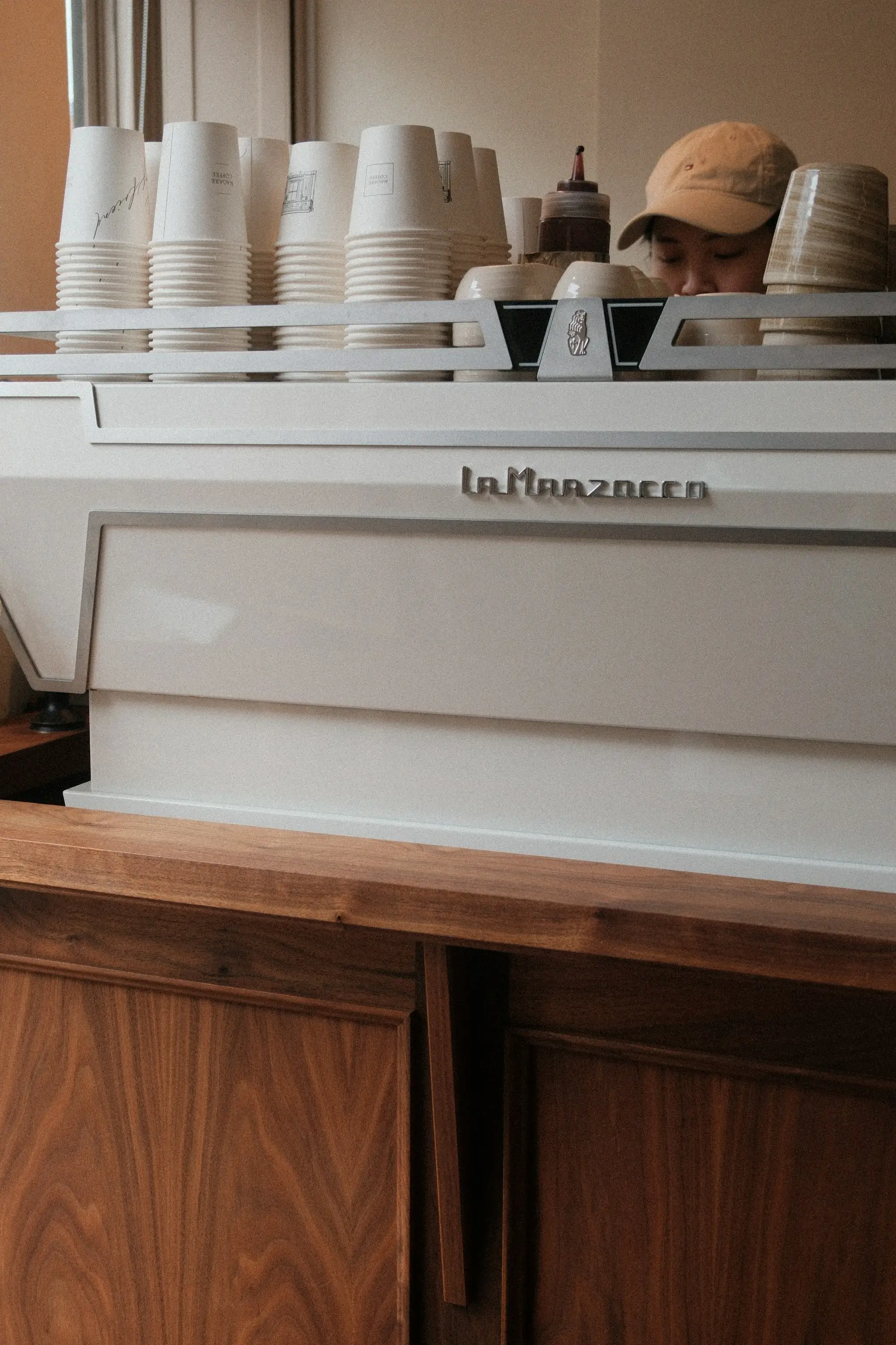 A barista working behind a commercial espresso machine