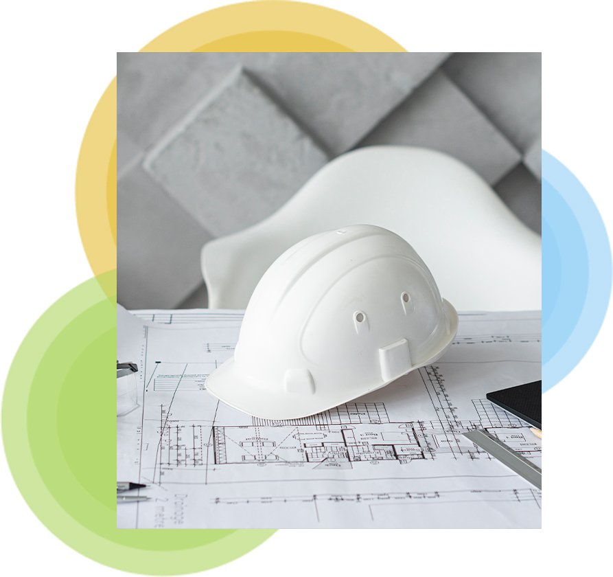 Construction hard hat resting on site plans
