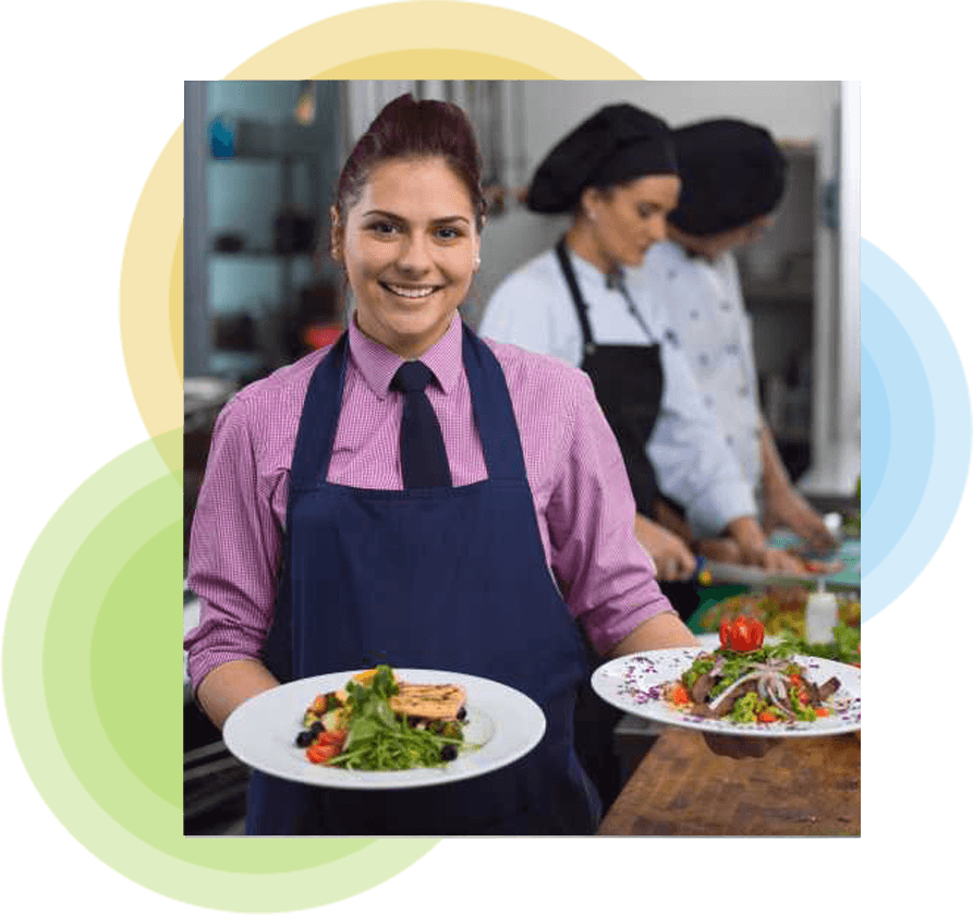 Hospitality worker carrying plates of food on the floor