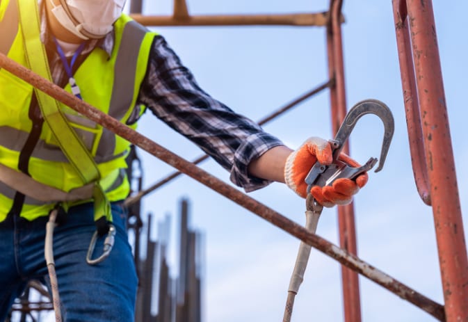 Worker safely using fall-arrest equipment while working at heights